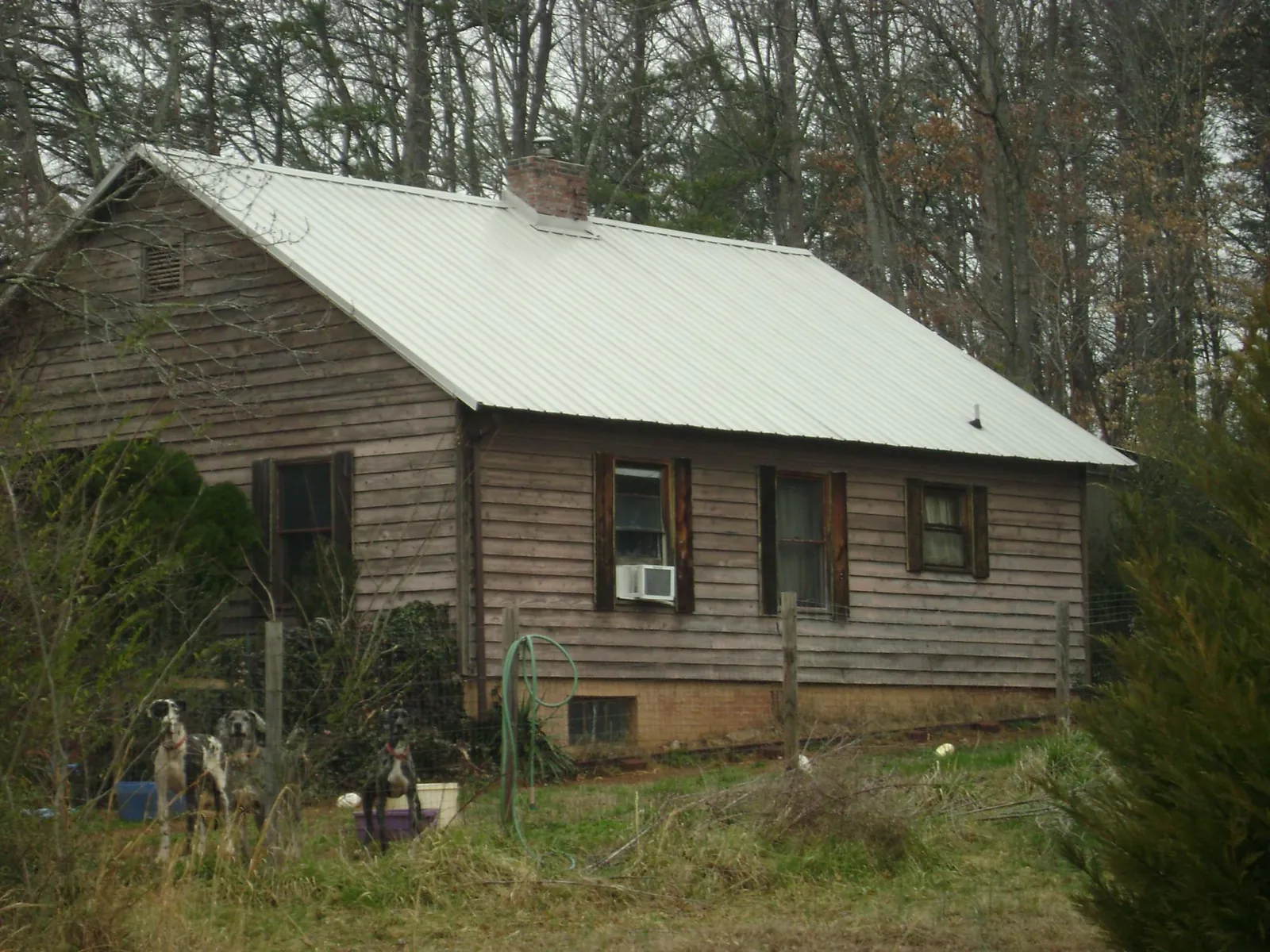 White metal roof on an old wood sided farmhouse, from a Metal Roof Installation job in Riner
